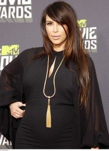 Kim covering her baby bump!